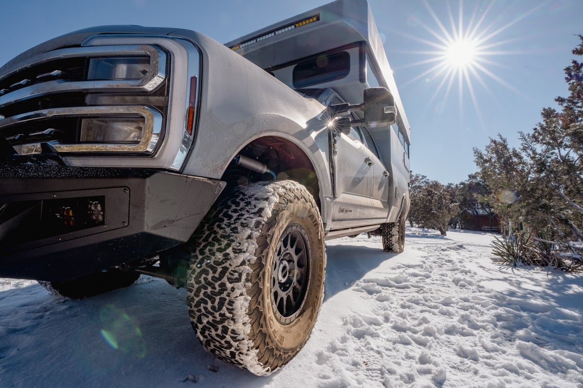 close up of the tires on the Rossmonster Baja Trail LX truck camper in the snow