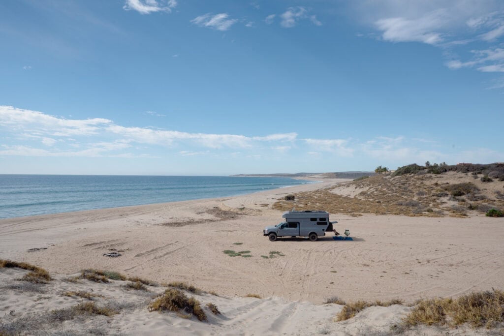 Rossmonster Baja Trail LX adventure truck camper parked on the beach in Baja next to the ocean