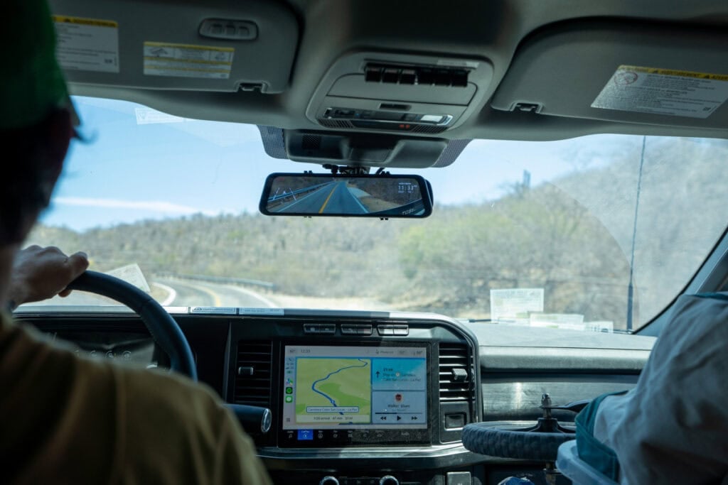 The Wolfbox rear view mirror and apple car play screen in the F350 of the Rossmonster Baja Trail LX