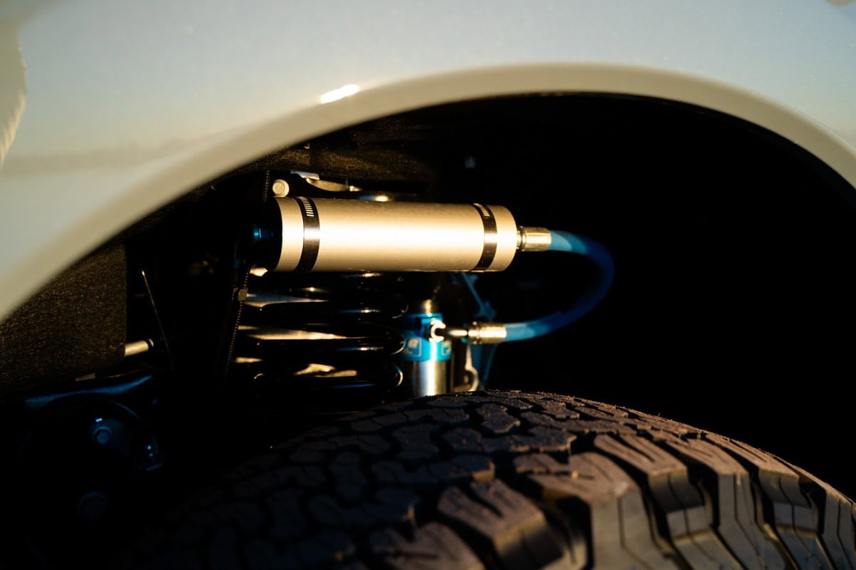 closeup of the suspension in the Rossmonster Baja Trail LX truck camper on a dirt road