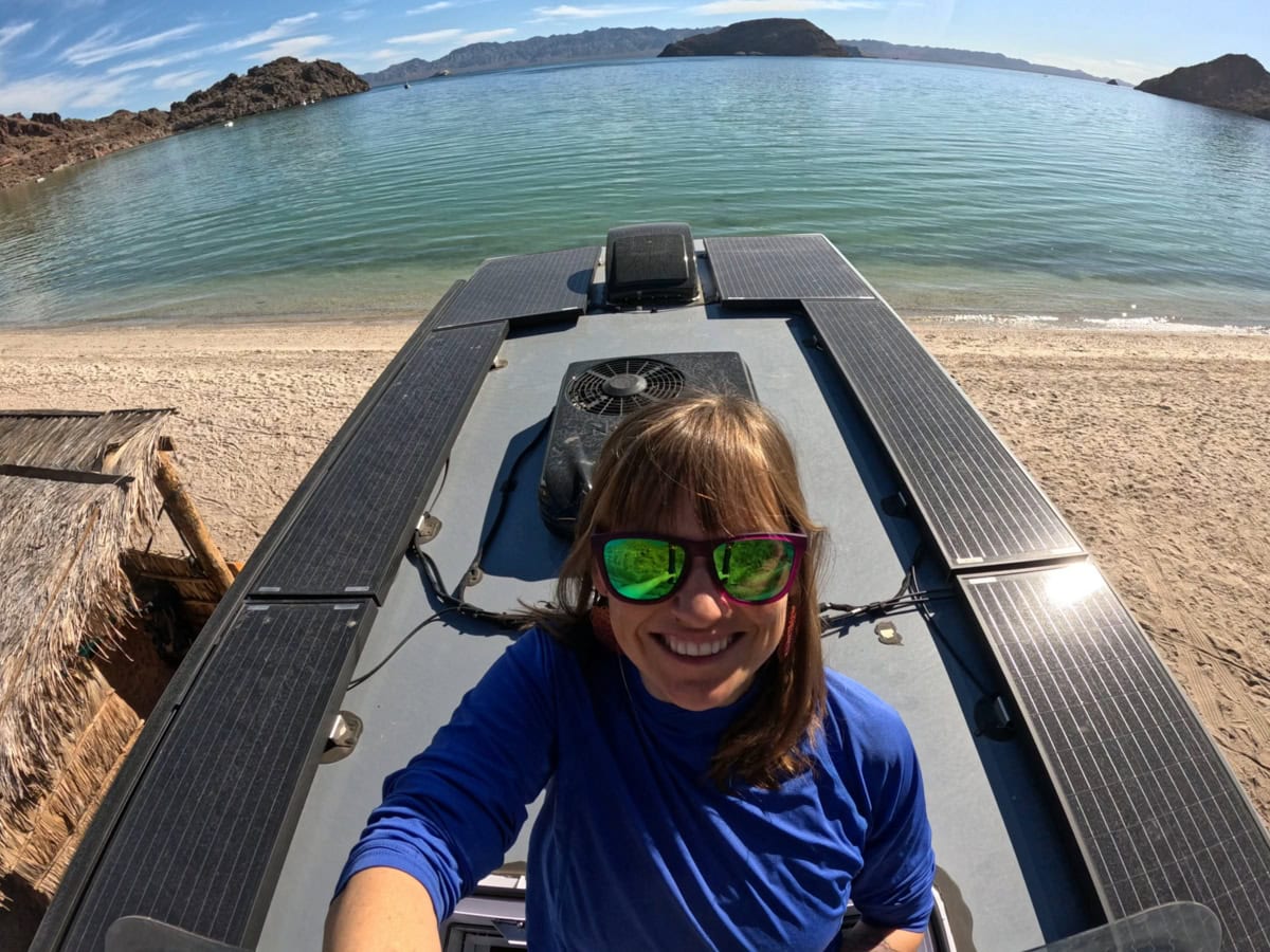 Kristen Bor standing in the skylight showing the roof of the Rossmonster Baja Trail LX