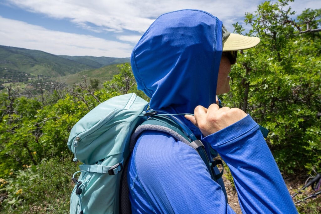 Closeup of kristn bor pulling the load lifter straps on the deuter trail 28 sl daypack