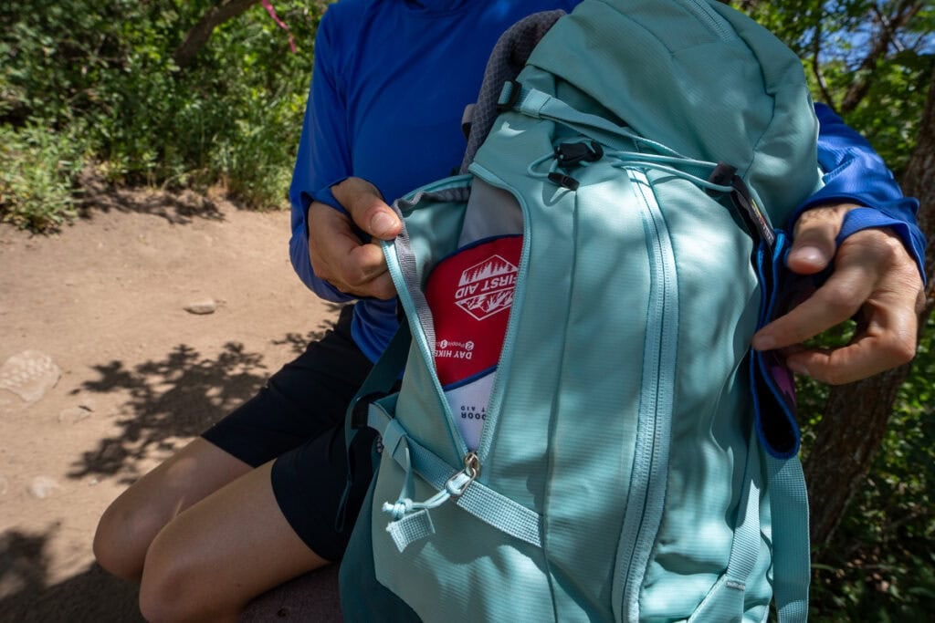 Side pocket with a first aid kit on the deuter trail 28 sl hiking backpack