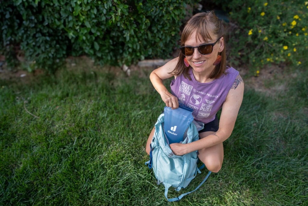 Kristen Bor putting a hydration reservoir into the hydration sleeve on the deuter trail sl backpack