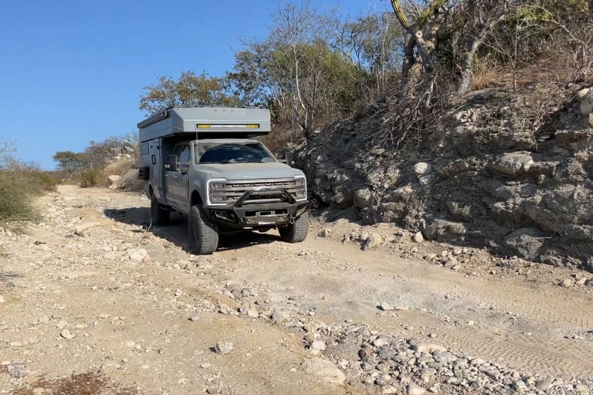 Rossmonster Baja Trail expedition truck driving on a rough dirt road